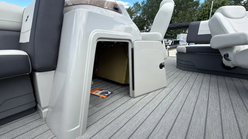 Slide: The Image of The image shows the interior of a Starcraft EX 20 Q DH boat with an open storage compartment. - 25