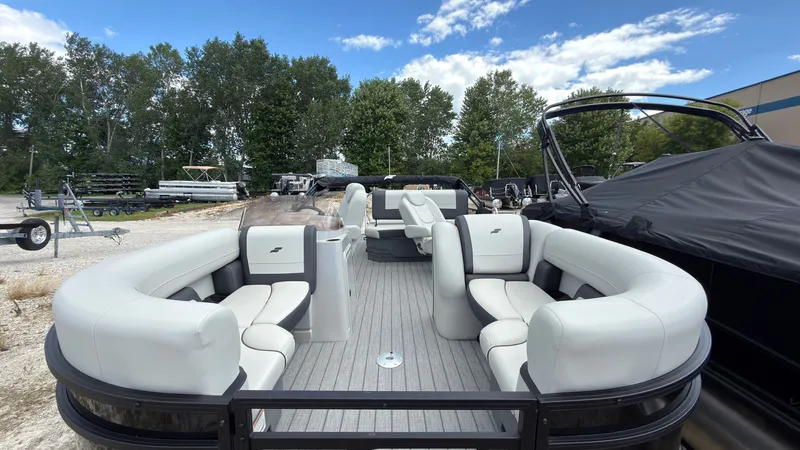 Slide: The Image of The image shows a Starcraft EX 20 Q DH pontoon boat with gray upholstery and an open deck layout. - 7