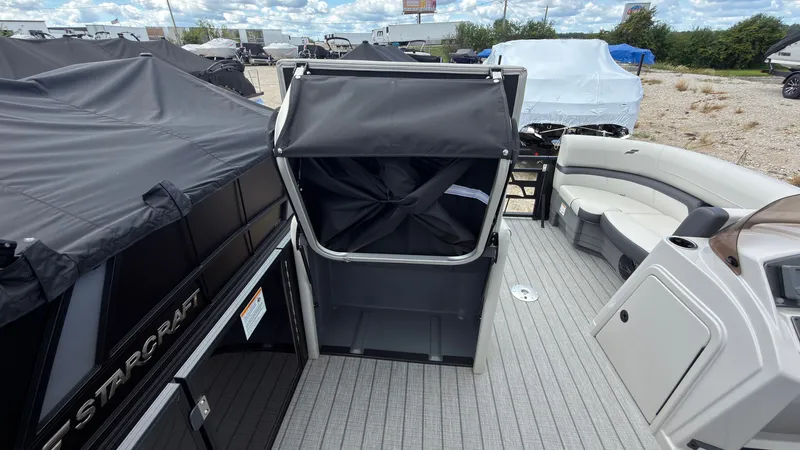 Slide: The Image of The image shows the deck of a Starcraft EX 20 Q DH boat with seating area and cover. - 29
