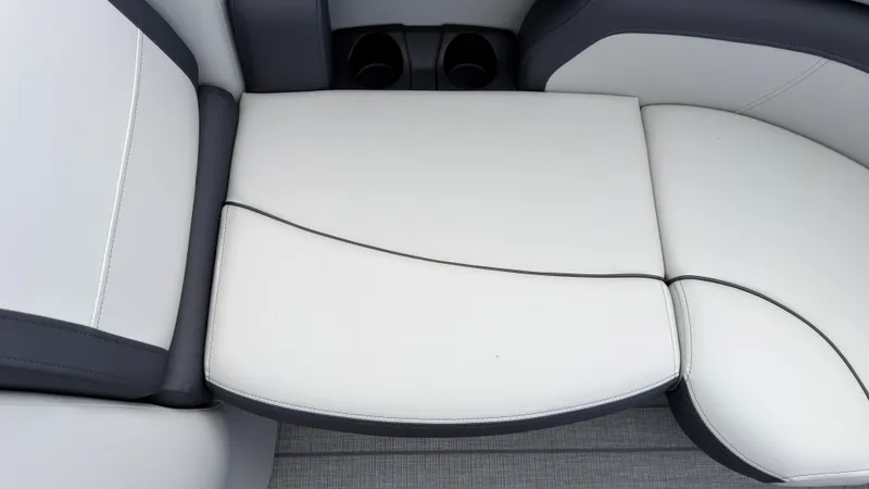 Slide: The Image of Close-up of a white and gray boat seat with cup holders in the background. - 13