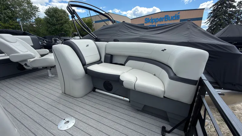 Slide: The Image of The image shows the sleek, white seating area of a 2027 Starcraft EX 20 Q DH boat. - 9