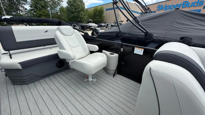 Slide: The Image of The image shows the interior of a Starcraft EX 20 Q DH boat with white seats and gray flooring. - 26