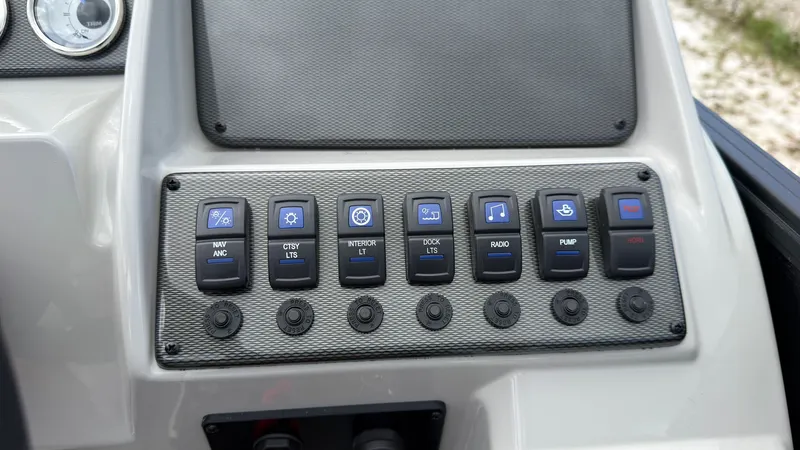 Slide: The Image of Control panel of a Starcraft EX 20 Q DH boat with various switches and buttons. - 35