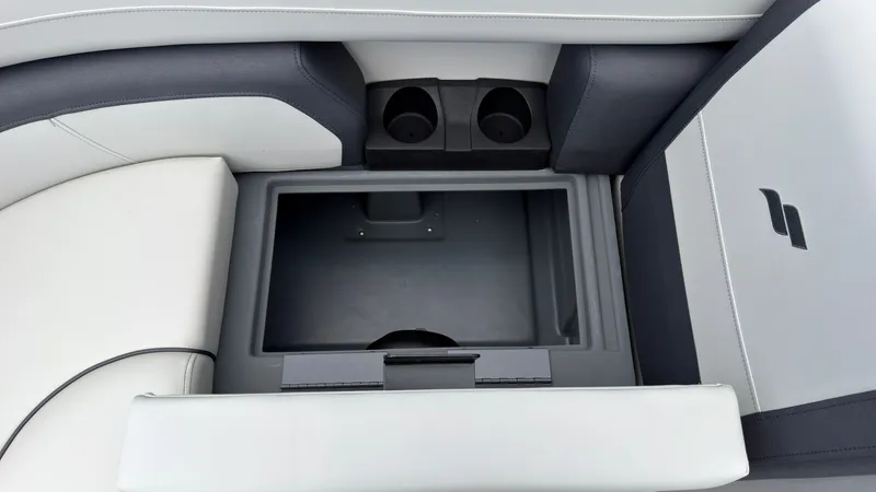 Slide: The Image of The image shows a storage compartment in a boat with two cup holders. - 20