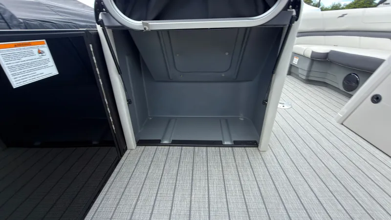 Slide: The Image of Storage compartment on a Starcraft EX 20 Q DH boat with gray flooring. - 30