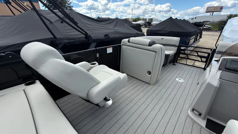 Slide: The Image of The image shows the deck of a 2027 Starcraft EX 20 Q DH with white seating. - 27
