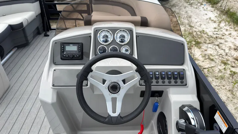 Slide: The Image of The image shows the helm of a Starcraft EX 20 Q DH boat with modern instruments. - 32