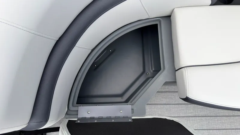 Slide: The Image of Close-up of a seating area with storage compartment in a Starcraft EX 20 Q DH boat. - 18