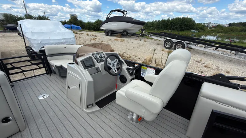 Slide: The Image of The image shows the cockpit of a 2027 Starcraft EX 20 Q DH with a helm and comfortable seating. - 31