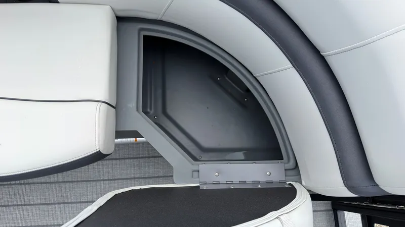 Slide: The Image of A gray seating compartment on a boat with cushioned seats and storage space underneath. - 12