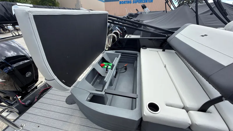 Slide: The Image of The image shows the rear of a Starcraft EX 20 Q DH boat with gray upholstery and storage space. - 46