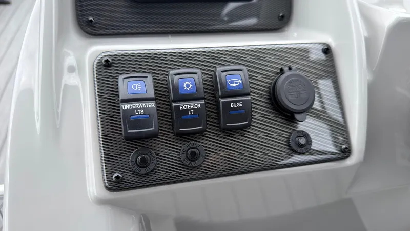 Slide: The Image of Close-up of a boat control panel with switches for underwater lights, exterior lights, and bilge pump. - 38