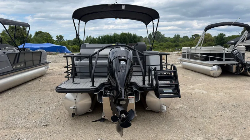 Slide: The Image of A 2027 Starcraft EXS 3 DL pontoon boat with a black outboard motor and sun canopy. - 6