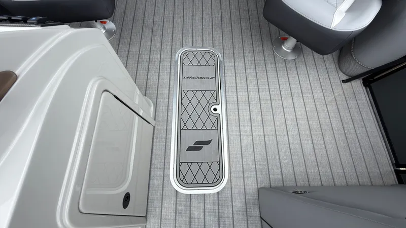 Slide: The Image of The image shows the floor of a Starcraft EXS 3 DL boat with a central access panel. - 24