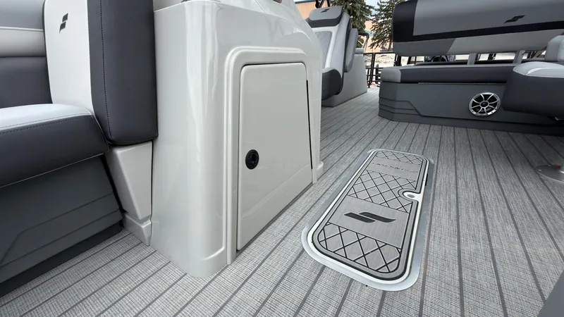 Slide: The Image of The image shows the deck of a Starcraft EXS 3 DL boat with gray flooring and seating. - 22