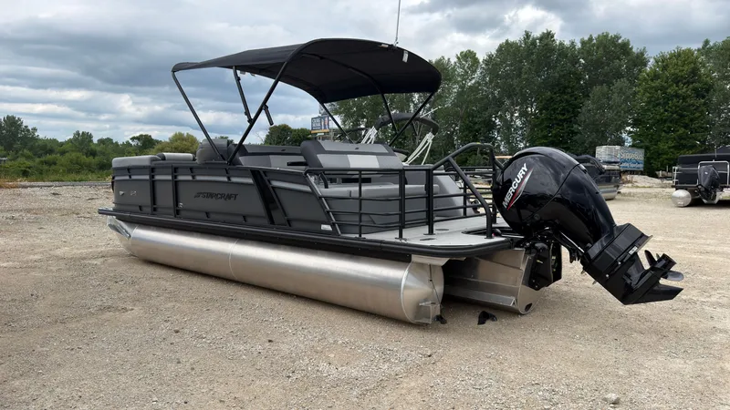 Slide: The Image of The image shows a 2027 Starcraft EXS 3 DL pontoon boat with a black canopy and outboard motor. - 4