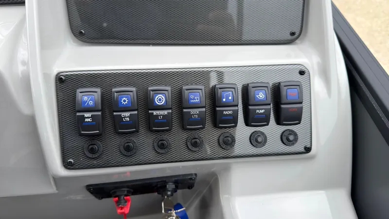 Slide: The Image of The image shows a control panel with various switches and buttons on a boat. - 42