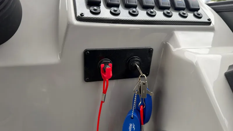 Slide: The Image of Close-up of a boat control panel with keys and switches. - 46