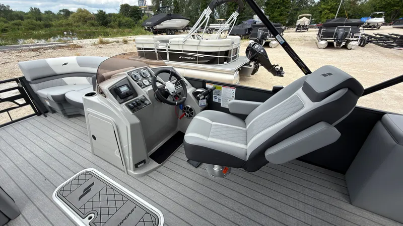 Slide: The Image of The image shows the cockpit of a 2027 Starcraft EXS 3 DL boat with gray seating. - 36