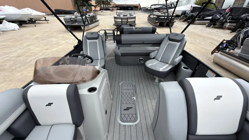 Slide: The Image of The image shows the interior of a 2027 Starcraft EXS 3 DL boat with gray seating. - 21