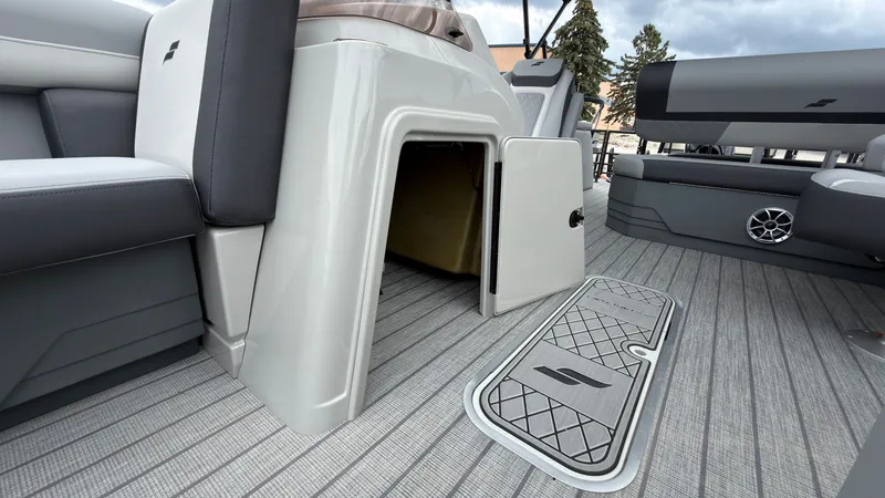 Slide: The Image of The image shows the interior of a Starcraft EXS 3 DL boat with gray flooring and storage space. - 23