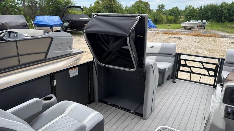 Slide: The Image of The image shows the interior of a Starcraft EXS 3 DL boat with gray seating and a foldable table. - 29