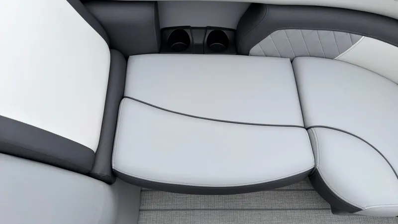 Slide: The Image of The Starcraft EXS 3 DL 2027 seating features gray and white upholstery with cup holders. - 13