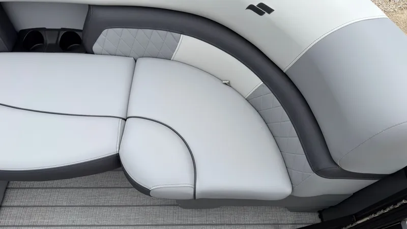 Slide: The Image of The 2027 Starcraft EXS 3 DL features sleek gray upholstery with quilted details and cup holders. - 11