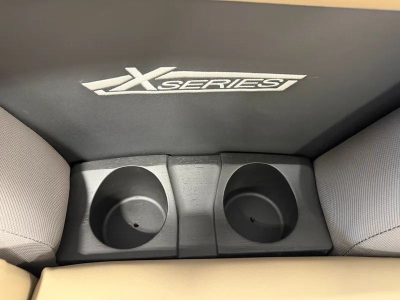 Slide: The Image of Two black cup holders in a Sylvan Mirage X1 CLZ DH boat, with X Series logo. - 9