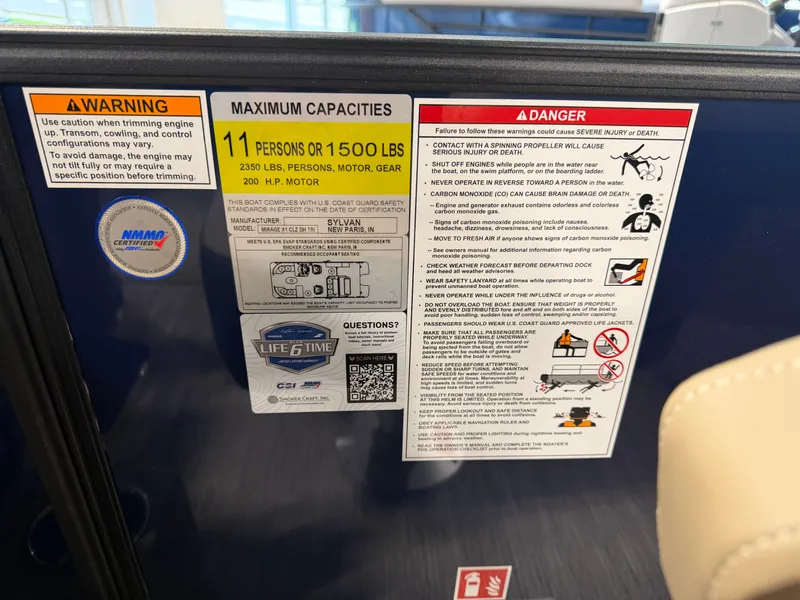 Slide: The Image of Warning labels and capacity information for the Sylvan MIRAGE X1 CLZ DH boat. - 25