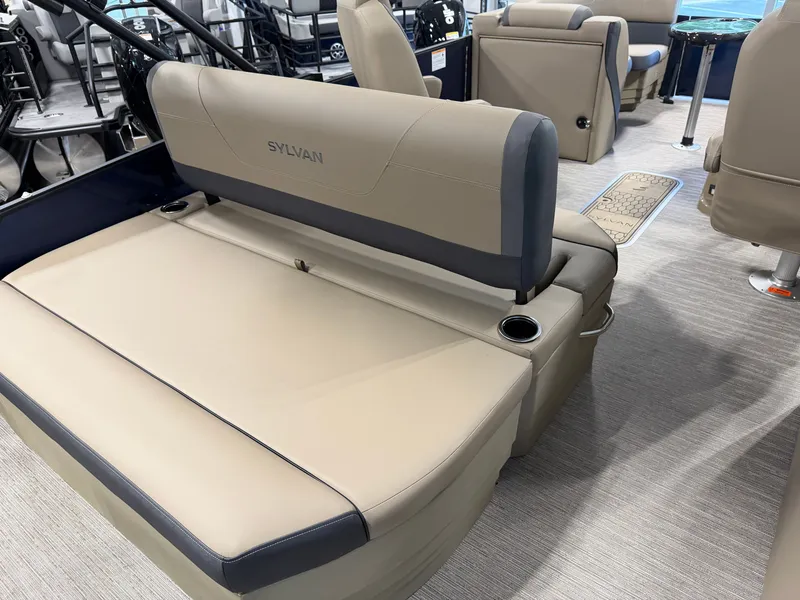 Slide: The Image of Interior of a 2026 Sylvan MIRAGE X1 CLZ DH with beige upholstery and cup holders. - 29
