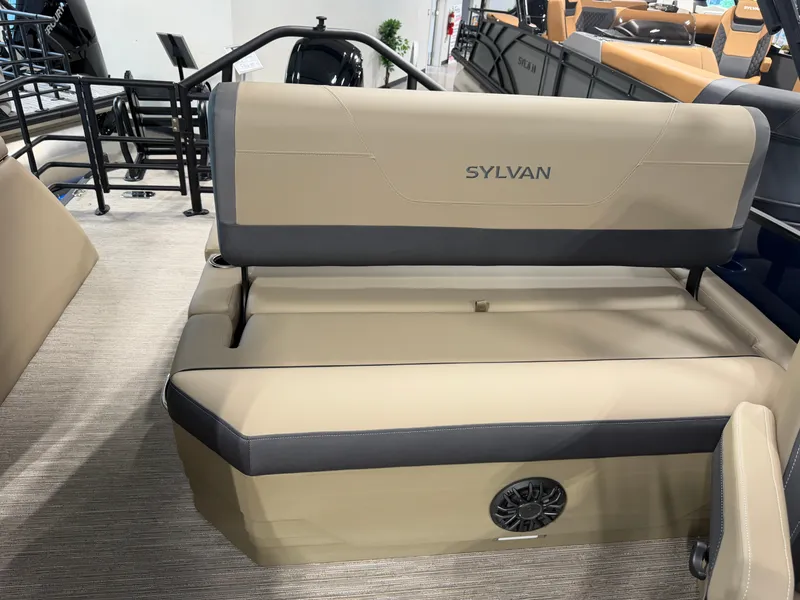 Slide: The Image of The image shows the beige seating of a Sylvan MIRAGE X1 CLZ DH boat with a speaker. - 26