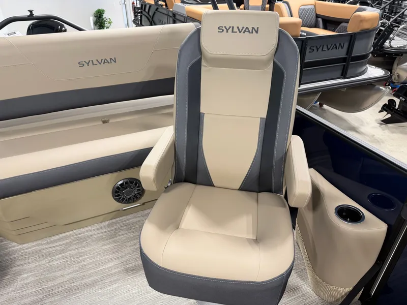 Slide: The Image of A modern boat seat with beige and gray upholstery, surrounded by more seats and a speaker. - 18