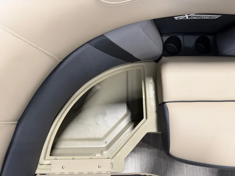 Slide: The Image of Close-up of a seating area with storage and cup holders on a Sylvan MIRAGE X1 CLZ DH boat. - 8