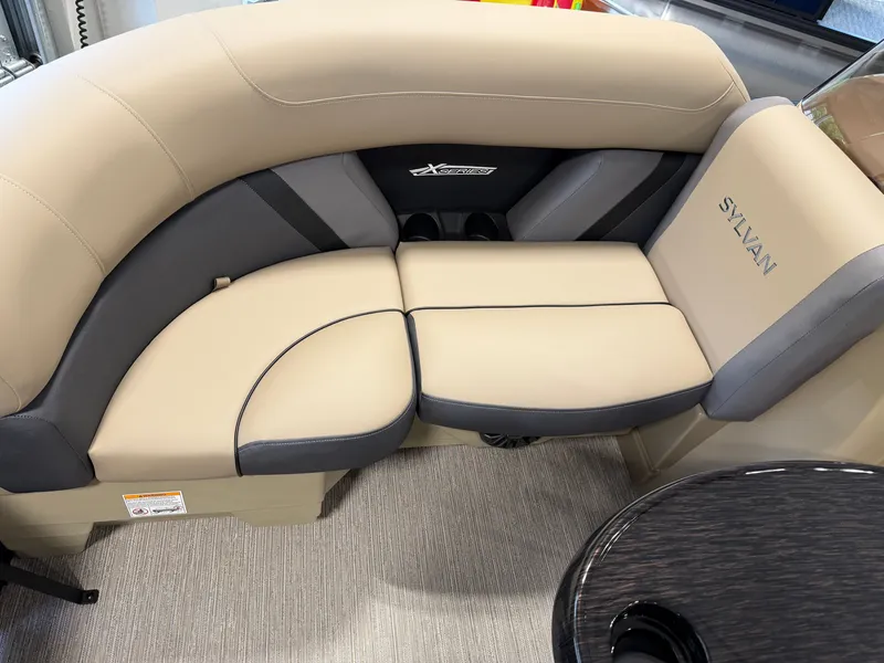 Slide: The Image of The image shows a beige and gray seating area in a Sylvan boat. - 7