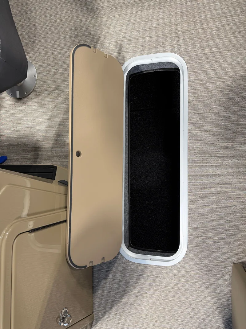 Slide: The Image of Open storage compartment with a beige lid on a boat. - 17