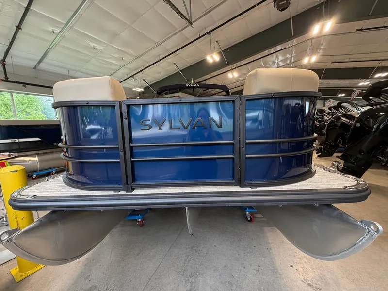 Slide: The Image of The image shows a 2026 Sylvan MIRAGE X1 CLZ DH pontoon boat in a storage facility. - 1