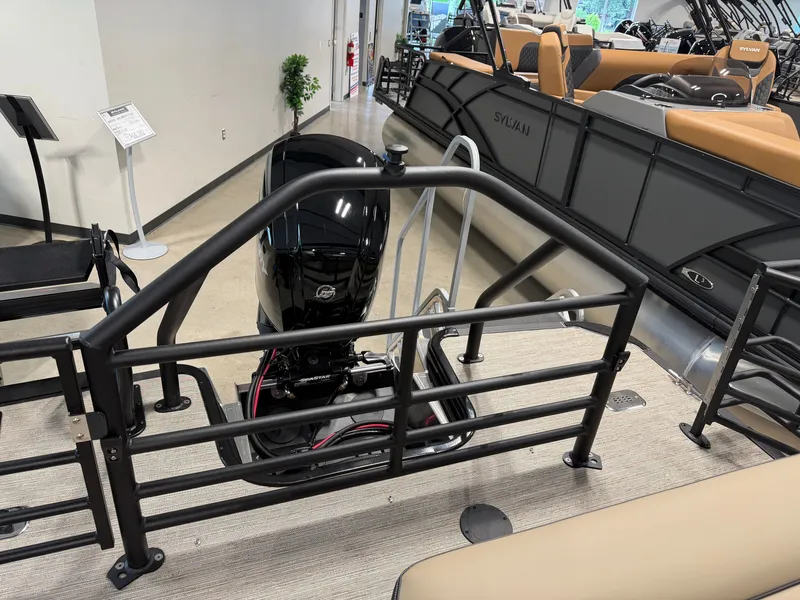Slide: The Image of The image shows the rear of a Sylvan MIRAGE X1 CLZ DH boat with an outboard motor. - 32
