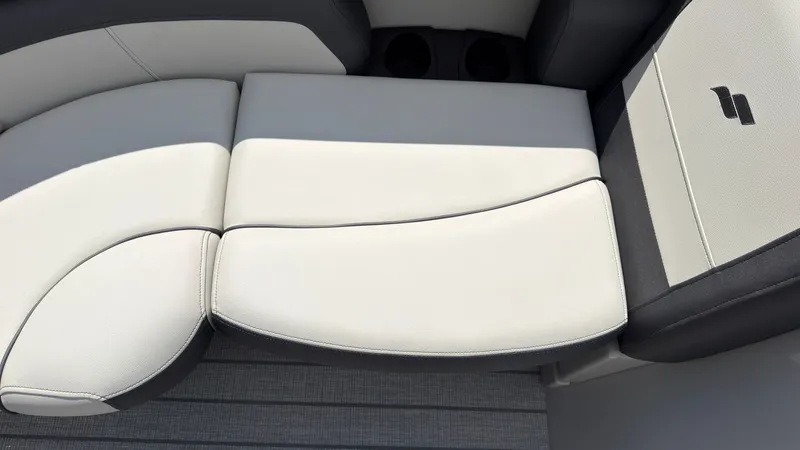 Slide: The Image of The image shows a sleek, cushioned bench seat with two-tone upholstery and cup holders. - 15