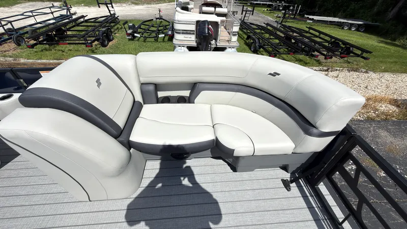 Slide: The Image of The image shows a white cushioned seating area on a boat, surrounded by trailers. - 17