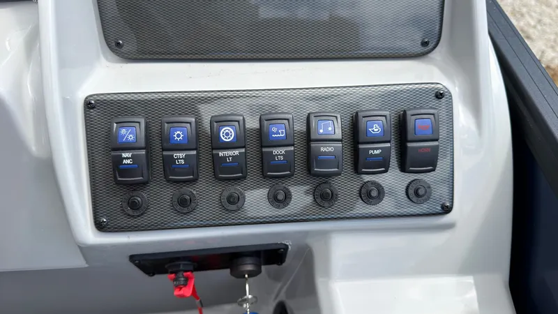 Slide: The Image of Control panel with various toggle switches for boat functions. - 38
