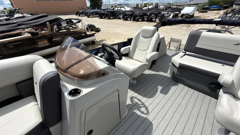 Slide: The Image of The image shows the cockpit of a 2027 Starcraft EX 20 Q DH with comfortable seating and a modern helm. - 33