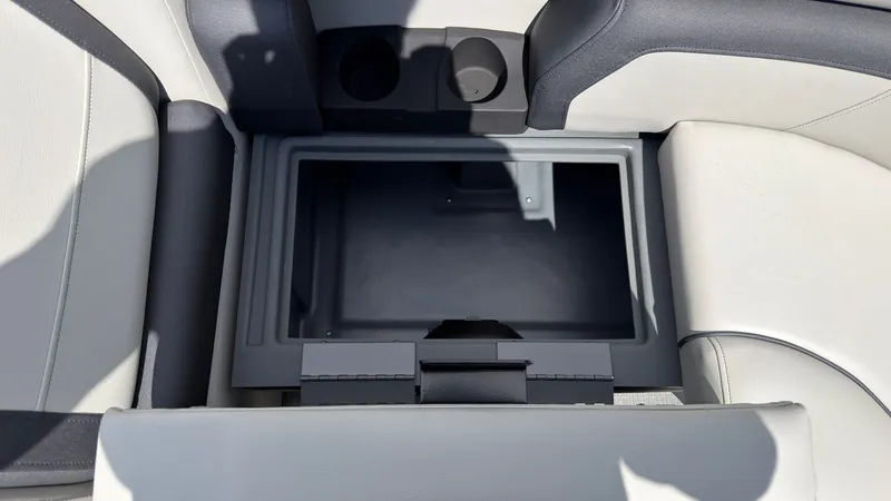 Slide: The Image of The image shows an open storage compartment on a boat with gray and white upholstery. - 21