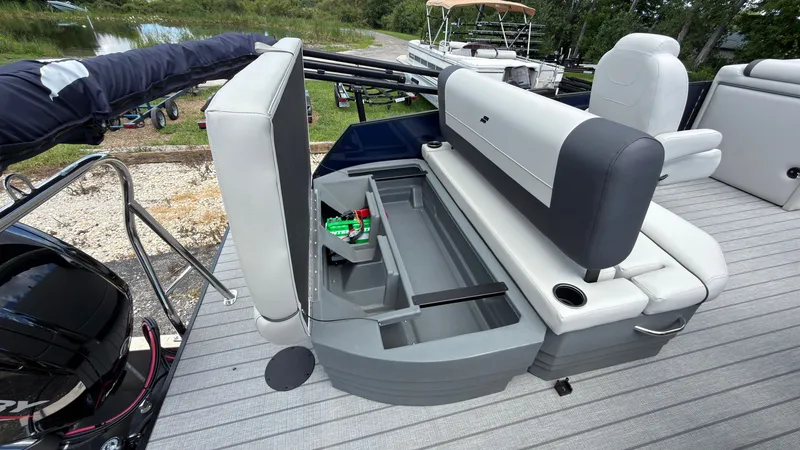 Slide: The Image of The image shows the interior of a Starcraft EX 20 Q DH boat with an open storage compartment. - 49