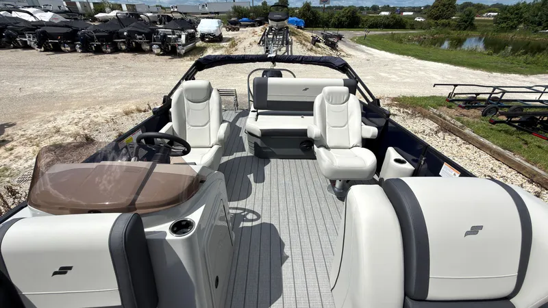 Slide: The Image of The image shows a 2027 Starcraft EX 20 Q DH boat with sleek seating and a modern helm. - 24