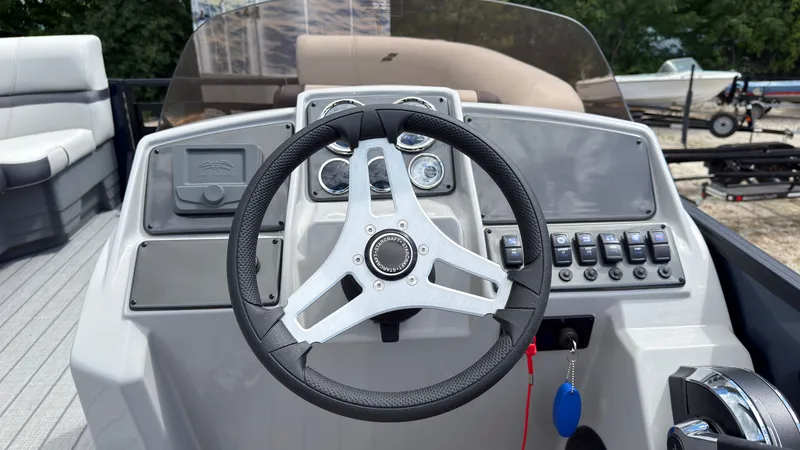 Slide: The Image of The image shows the helm of a Starcraft EX 20 Q DH boat with modern instruments. - 39