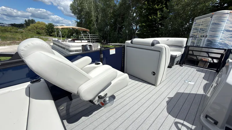 Slide: The Image of The image shows the deck of a 2027 Starcraft EX 20 Q DH with white seats and gray flooring. - 29