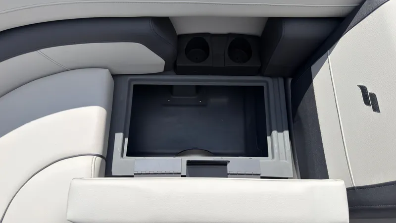 Slide: The Image of Interior view of a 2027 Starcraft EX 20 Q DH with storage compartment and cup holders. - 14