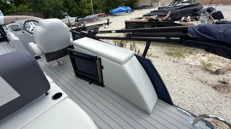 Slide: The Image of The image shows the deck of a 2027 Starcraft EX 20 Q DH boat with white seating and gray flooring. - 47