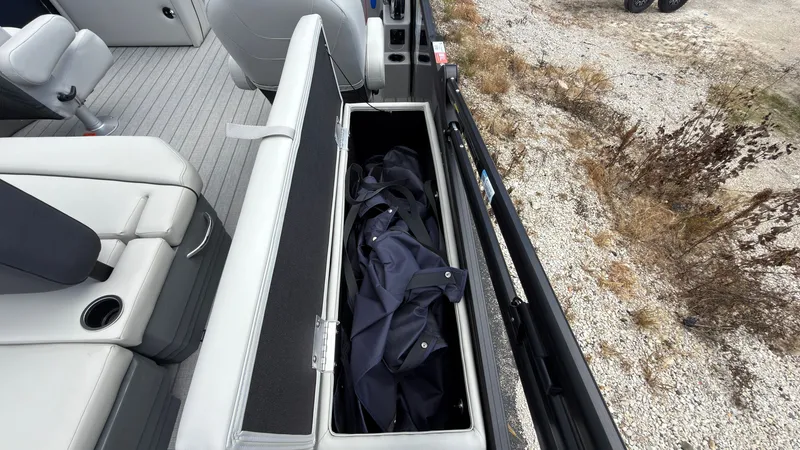 Slide: The Image of An open storage compartment on a boat with a jacket inside. - 48